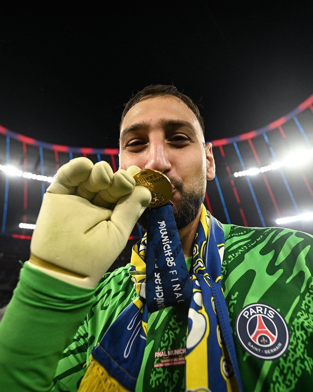 Gianluigi Donnarumma of PSG kissing the UEFA Champions League medal after winning the 2024–25 final, celebrating his triumph with the club.