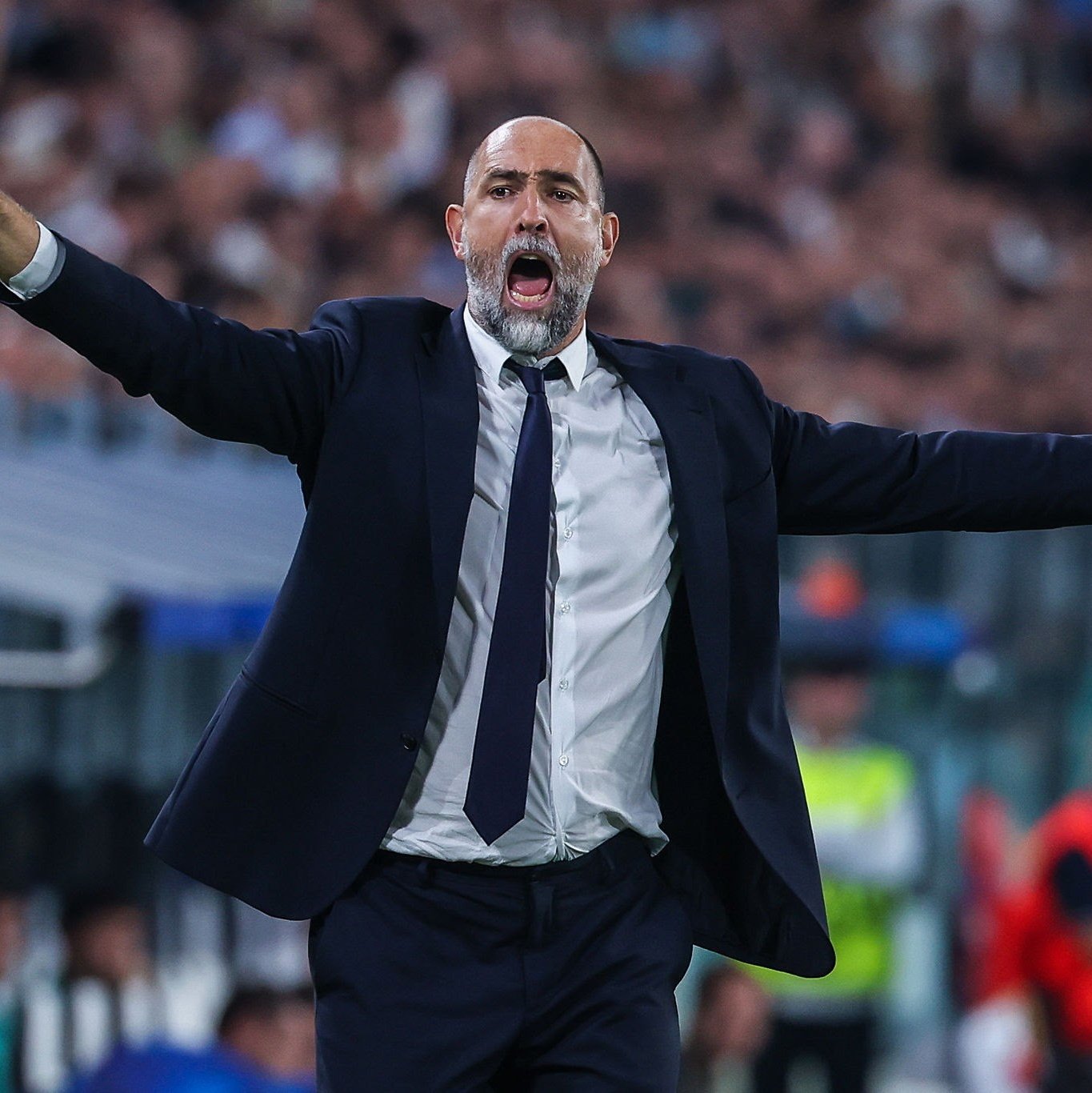 gor Tudor stands on the sideline gesturing and giving instructions to his team during a match.