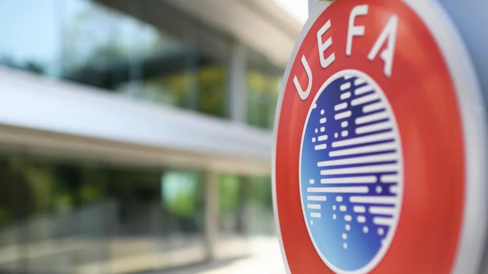 UEFA sign displayed on a building facade, featuring the organization’s logo and name against a clear sky background