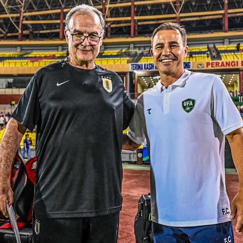 Fabio Cannavaro and Marcelo Bielsa share a post-match moment, smiling together before facing each other as opposing coaches.