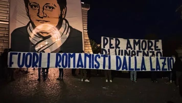 A protest banner displayed by Lazio fans reading “Let the Romans get out of Lazio…” in bold letters, held up inside the stadium as part of the Curva Nord’s demonstration.