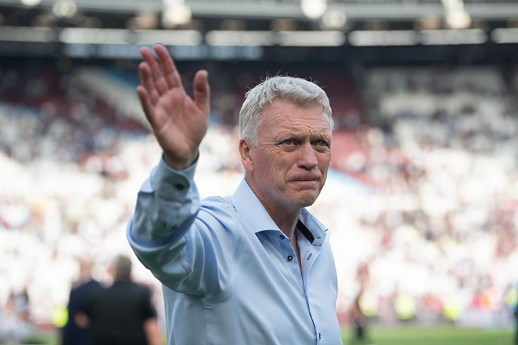 David Moyes waves to supporters after the match, his expression serious and visibly unhappy.