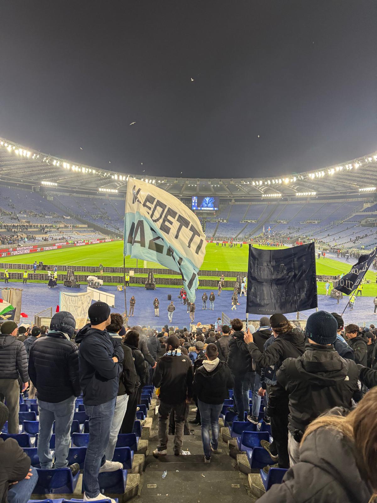 A Maledetti Laziali flag rippling through the Curva Nord during the match.