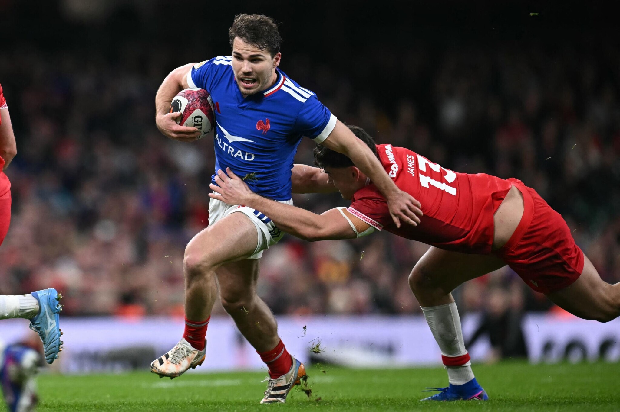 Wales vs France in the Six Nations at the Principality Stadium, with French players celebrating a decisive victory while Welsh players look dejected after the final whistle.