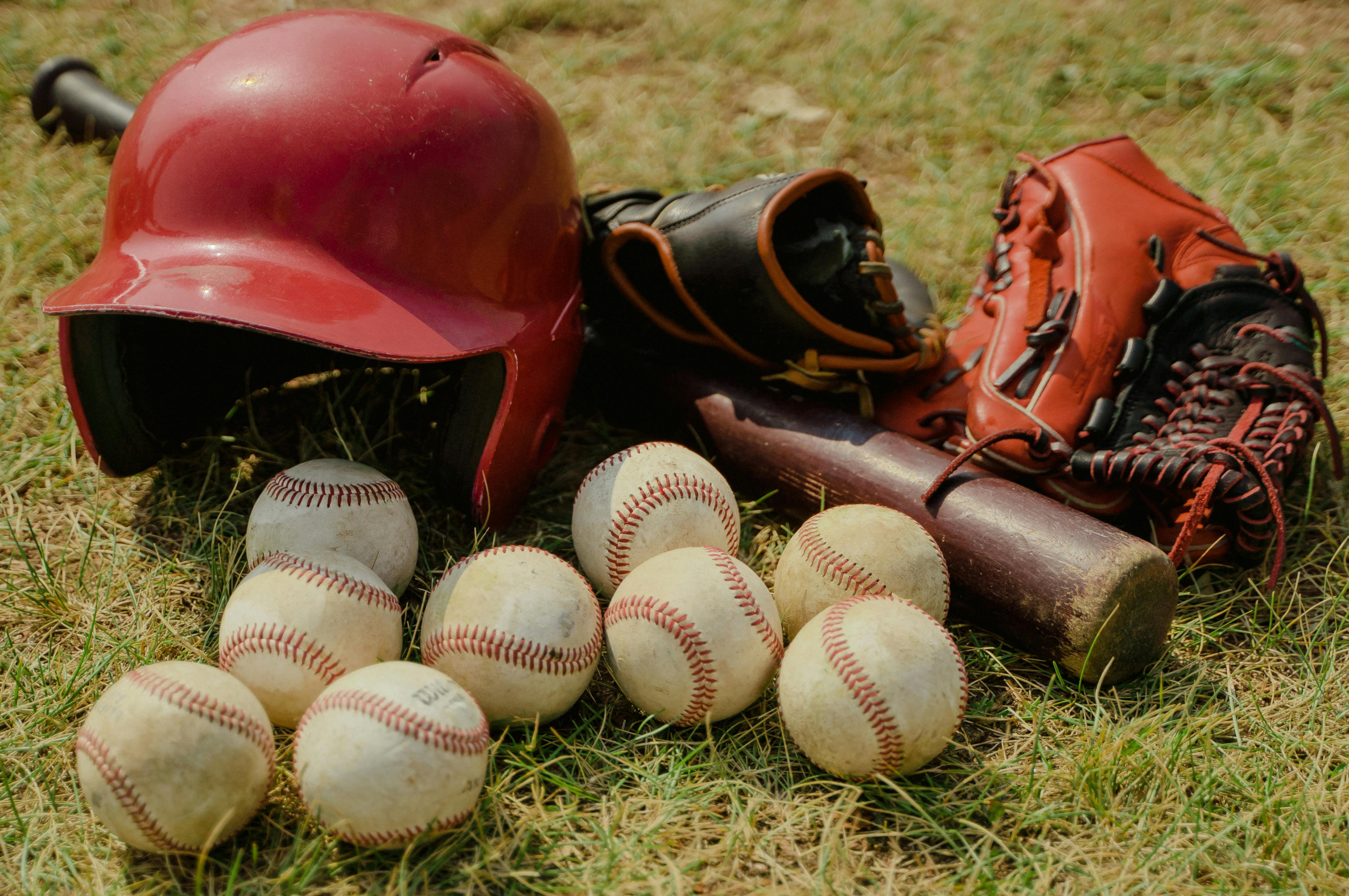Picture of a baseball bat, balls and equipment.