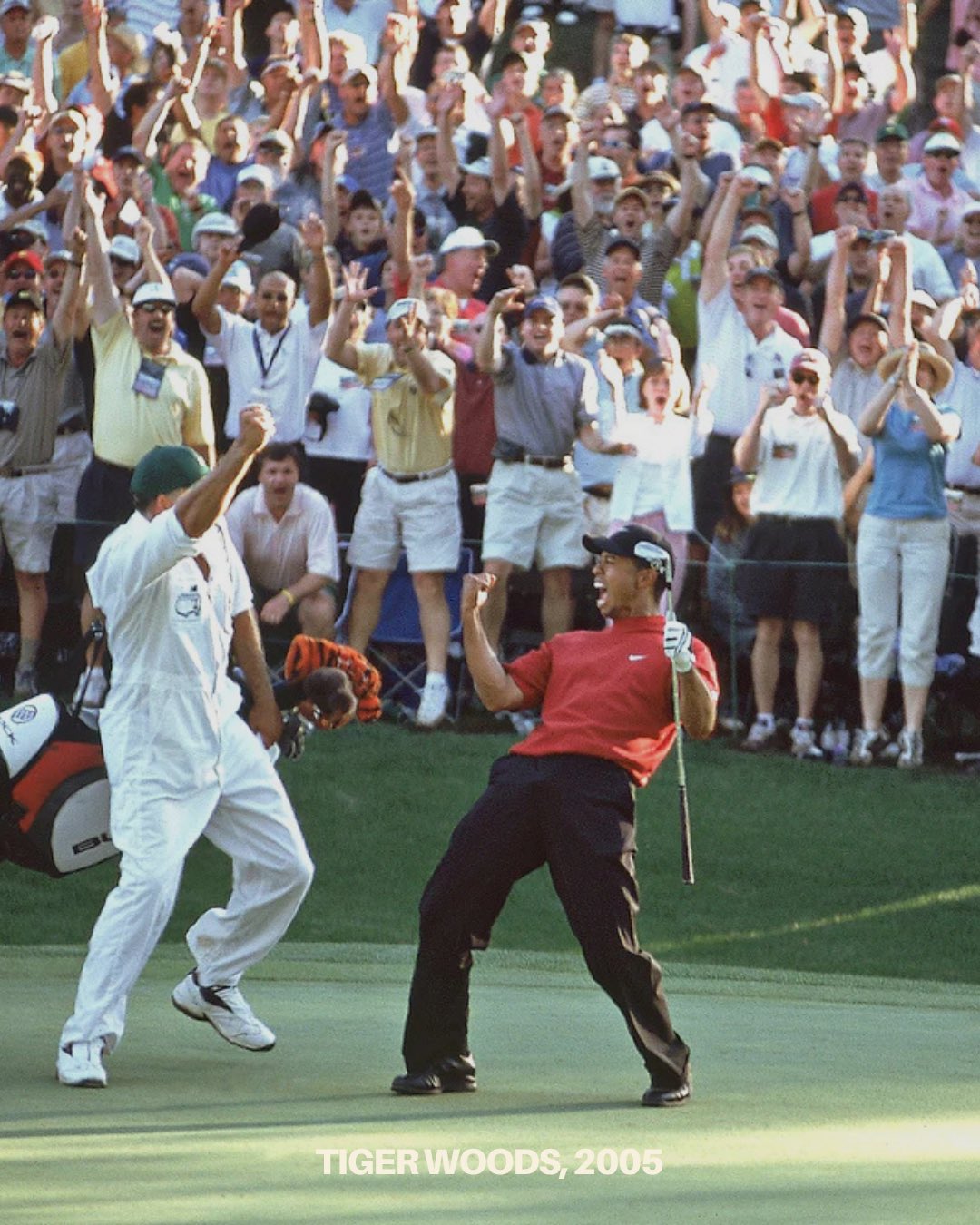 Tiger Woods celebrating with his caddy.